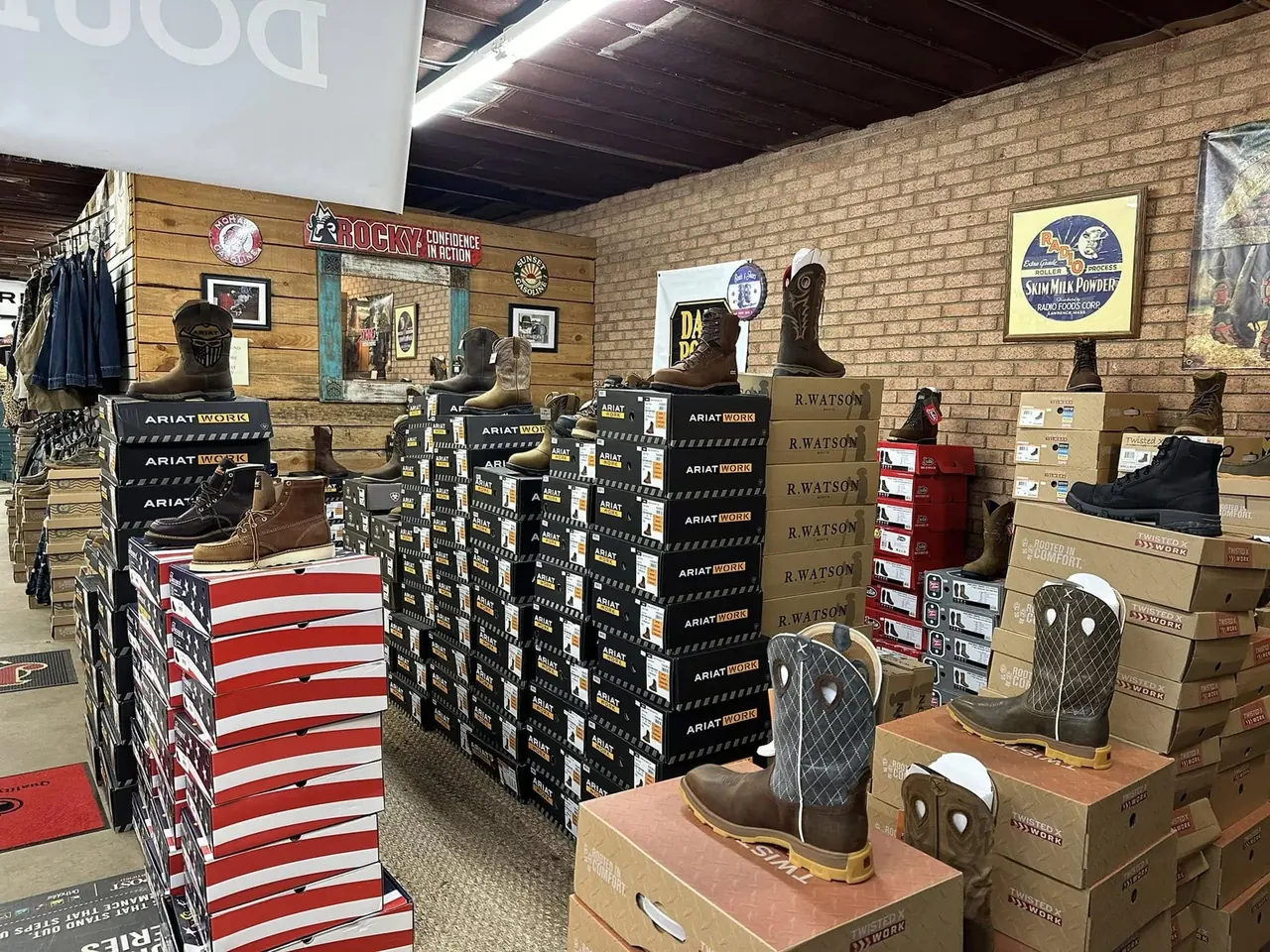 Wall of Ariat, R. Watson and Twisted X work boots and boxes at Cowboy Country Western Wear in Hickory, NC